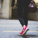 pair of women's legs walking down the street