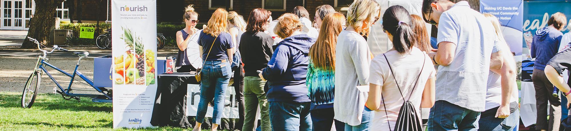 people standing in line for Nourish booth